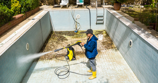 Swimming Pool Cleaning. Dirty pool, cleaning the pool ground with a pressure pump