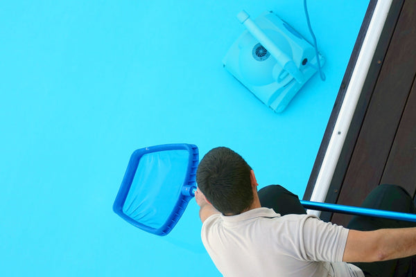 a pool cleaner doing swimming pool cleaning services